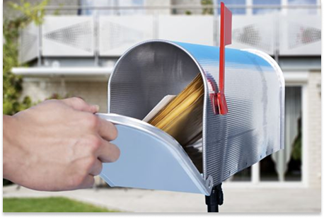 Hand retrieving mail from a mailbox